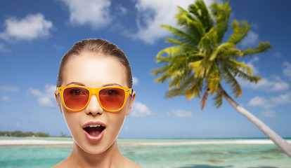 Image showing happy woman or teenage girl in sunglasses on beach