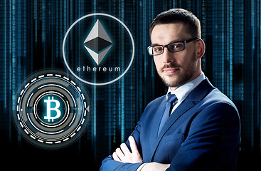 Image showing businessman with cryptocurrency holograms