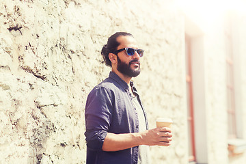 Image showing man drinking coffee from paper cup on street