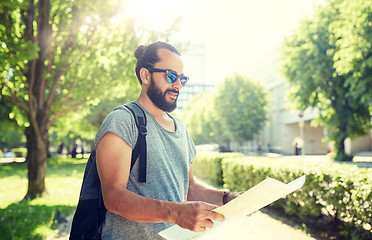 Image showing man traveling with backpack and map in city