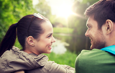 Image showing smiling couple with backpacks in nature