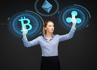 Image showing businesswoman with cryptocurrency holograms