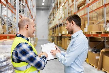 Image showing worker and businessman with clipboard at warehouse