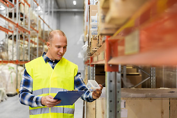 Image showing warehouse worker with clipboard and plastic box