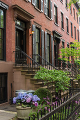 Image showing Row of old brownstone buildings along an empty sidewalk block in the Greenwich Village neighborhood of Manhattan, New York City NYC