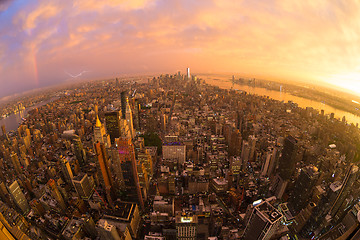 Image showing New York City skyline with Manhattan skyscrapers at dramatic stormy sunset, USA.