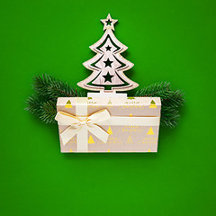 Image showing Christmas decoration green background with fir tree and gift box