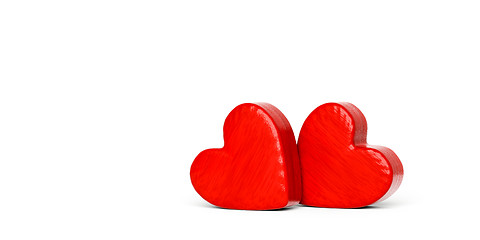 Image showing Two red wooden hearts on a white background