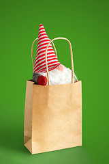 Image showing christmas gnome in a paper bag isolated on green background