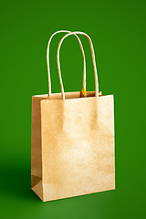 Image showing beige paper bag isolated on green background