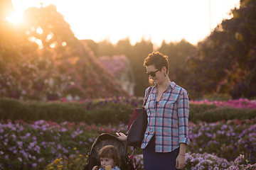 Image showing mother and daughter in flower garden