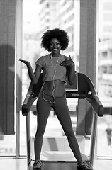 Image showing afro american woman running on a treadmill