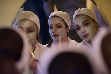 Image showing women putting face masks in the bathroom