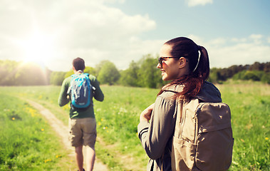 Image showing happy couple with backpacks hiking outdoors