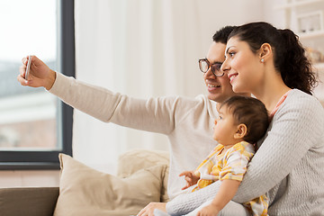 Image showing mother and father with baby taking selfie at home