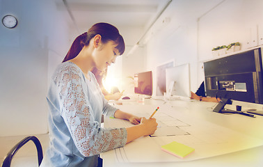 Image showing architect woman drawing on blueprint at office