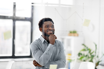 Image showing businessman looking at glass board at office