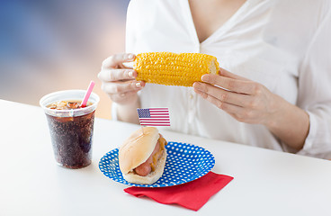 Image showing woman eating corn with hot dog and cola