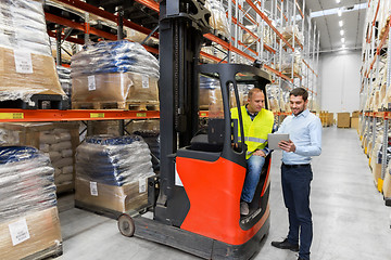 Image showing men with tablet pc and forklift at warehouse