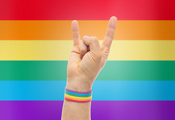 Image showing hand with gay pride rainbow wristband shows rock