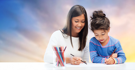 Image showing mother and daughter drawing over evening sky