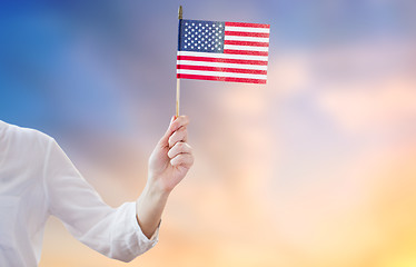 Image showing close up of woman holding american flag in hand