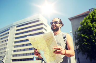 Image showing man traveling with backpack and map in city