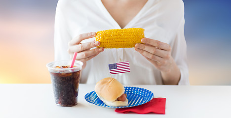 Image showing woman eating corn with hot dog and cola