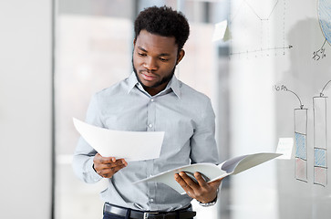 Image showing african american businessman with folder at office