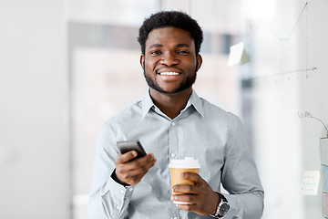 Image showing businessman with smartphone and coffee at office