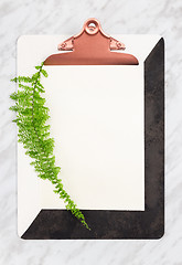 Image showing Stylish clipboard with blank paper sheet and green plant