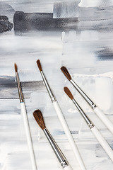 Image showing Paint brushes on black and white artistic background