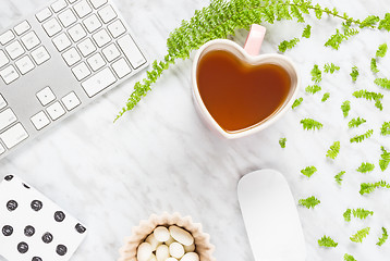 Image showing Beautiful home office workspace with heart-shaped teacup