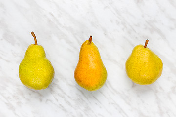 Image showing Ripe pears on marble background