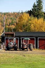 Image showing Two old rusty tractors 