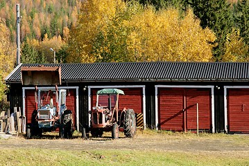 Image showing Two rusty old tractors