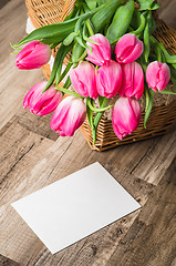 Image showing Beautiful bouquet of pink tulips and congratulations on the tabl