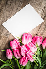 Image showing Beautiful bouquet of pink tulips and congratulations on the tabl