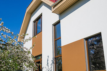 Image showing The facade of the house with a reflection in the windows of flow