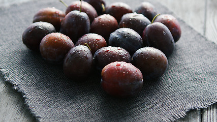 Image showing Wet fresh plums on napkin