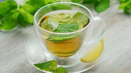Image showing Cup of green tea with mint and lemon