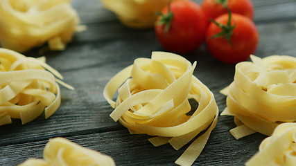 Image showing Spaghetti in shape of balls with tomatoes