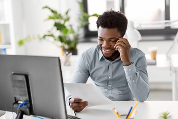 Image showing businessman calling on smartphone at office