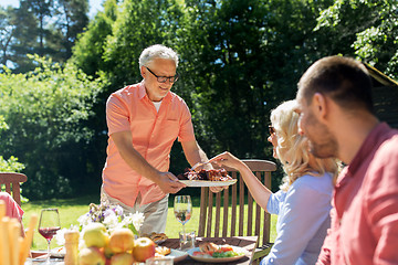 Image showing family having dinner or barbecue at summer garden