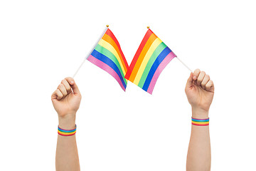 Image showing hand with gay pride rainbow flags and wristbands