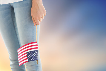 Image showing close up of woman holding american flag in hand