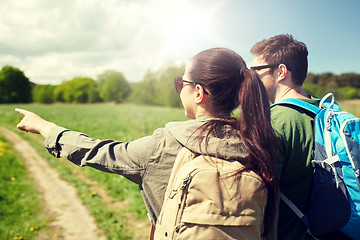 Image showing happy couple with backpacks hiking outdoors