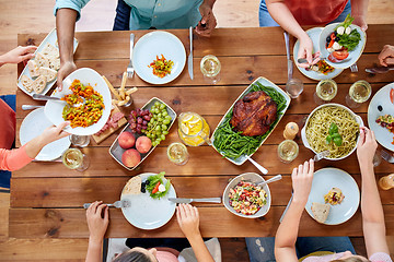 Image showing group of people eating at table with food