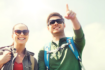 Image showing happy couple with backpacks hiking outdoors