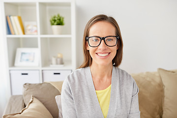 Image showing happy smiling woman in eyeglasses at home